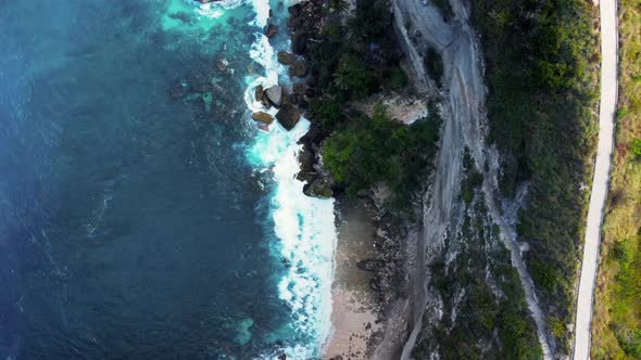 Top down view on hidden sandy beach with azure water