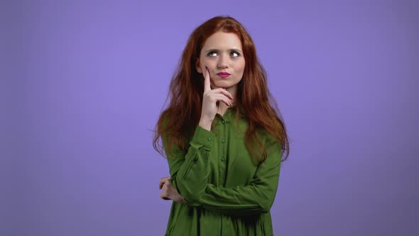 Portrait of Woman Having Idea Moment Pointing Finger Up on Violet Studio Background