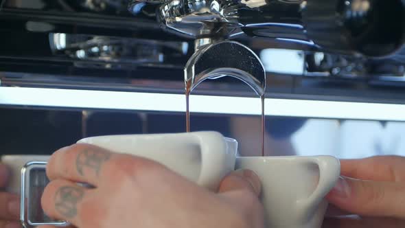 Professional Espresso Machine Pouring Strong Looking Fresh Coffee Into a Neat Ceramic Cup