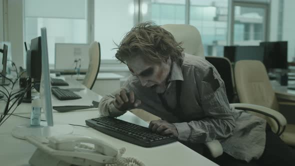 Zombie Office Worker Trying to Type on Computer