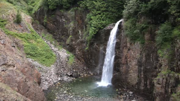 Beautiful Franklin Falls hidden amongst dense evergreen forest of the Washington Cascades, aerial