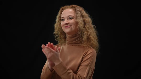 Smiling Confident Woman Clapping Smiling Standing at Black Background