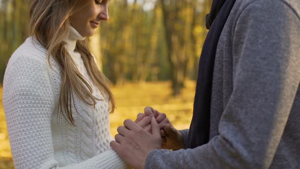 Guy Warming His Girlfriends Hands and Gently Kissing Them, Romantic Atmosphere