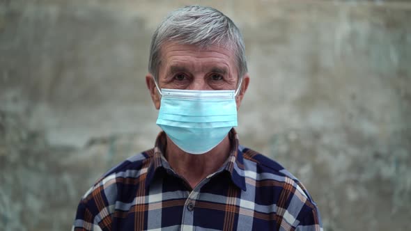 An Old Man Is Using Face Mask for Protect From Virus Against the Second Wave Quarantine Coronavirus