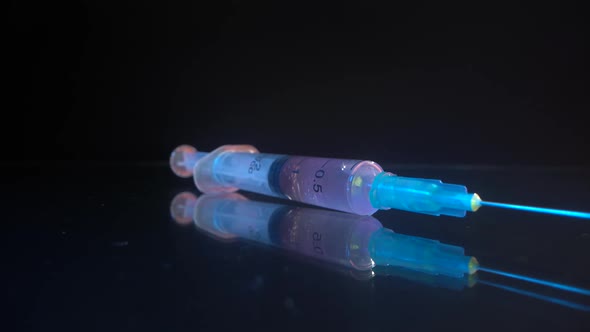 Syringe in Glass with Reflection. Vaccine Vaccination Treatment Covid-19 Coronavirus COVID-19 Flu