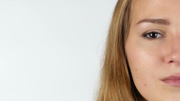 Portrait Of Half Female Face Looking at Camera, White Background