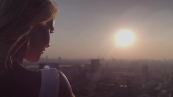 Blond Young Woman Enjoying Sunlight At Sunset