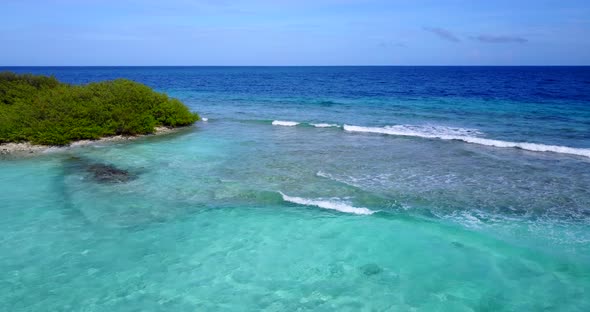 Tropical flying copy space shot of a sandy white paradise beach and aqua blue ocean background in hi