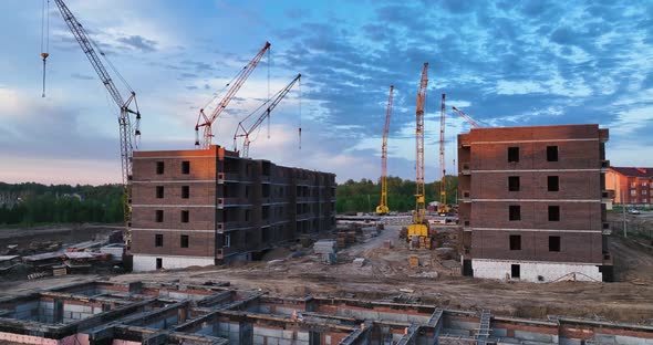 Construction site of low-rise brick houses in summer. Aerial view