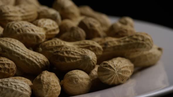 Cinematic, rotating shot of peanuts on a white surface - PEANUTS 029