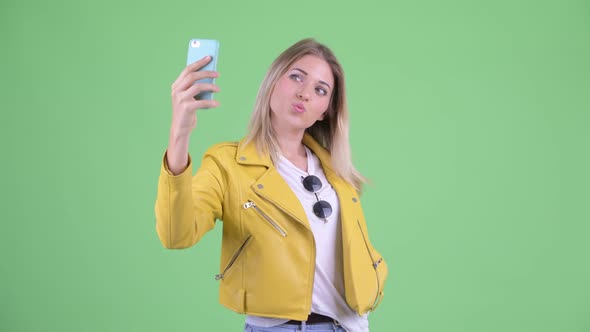 Happy Young Rebellious Blonde Woman Taking Selfie