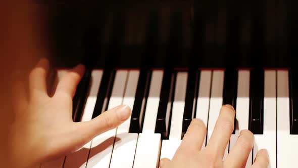 Close-up of woman playing a piano