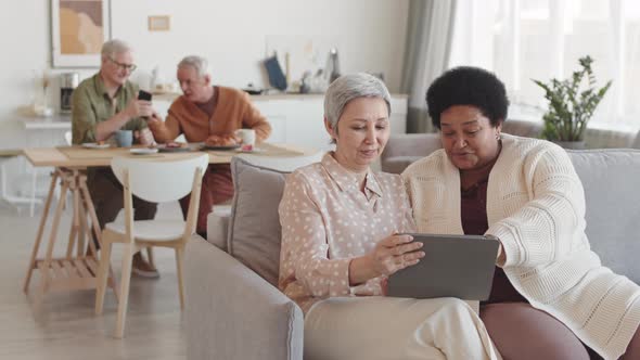Senior Female Friends Using Tablet Computer