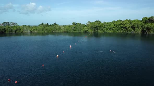 Reverse drone shot in the Cenote Azul