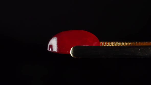 Natural Hessonite Brown Garnet Gemstone in the Tweezer on the Turn Table