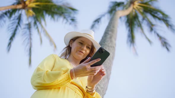 Happy Caucasian Smiling Woman Holding Cell Phone Using Smartphone Hawaiian Beach