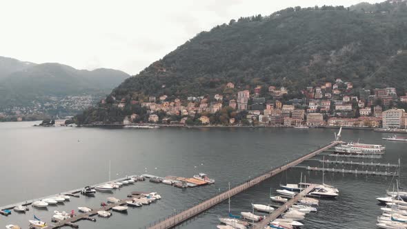 Yachts and motorboats at upscale Como lake marina. Lakeside picturesque town, Lombardy, Italy