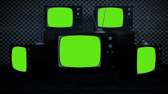 An exhibition of old-fashioned retro color tv sets with tuner antennas.