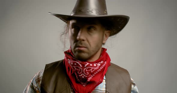 Handsome american cowboy wearing a red bandana and a leather hat, 4k