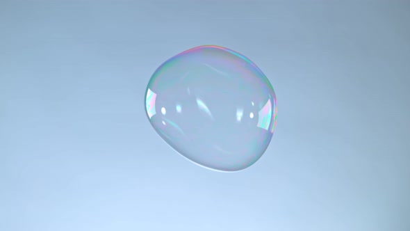 Super Slow Motion Shot of Flying and Cracking Colorful Soap Bubble on Grey Background at 1000 Fps