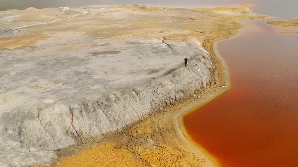 Ural Mars Man is walking on the ancient stones Mars planet Red lake in the mountains