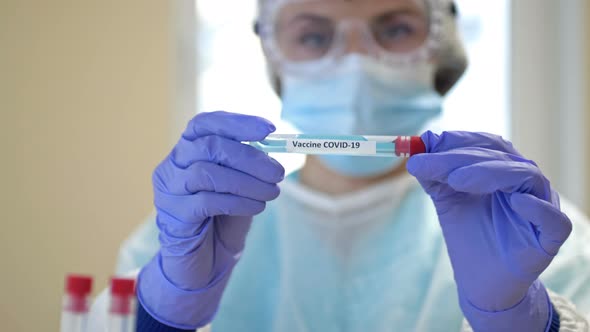 Professional Female Scientist Wearing Glasses Mask Holds 2019Ncov Coronavirus Vaccine Sample Her