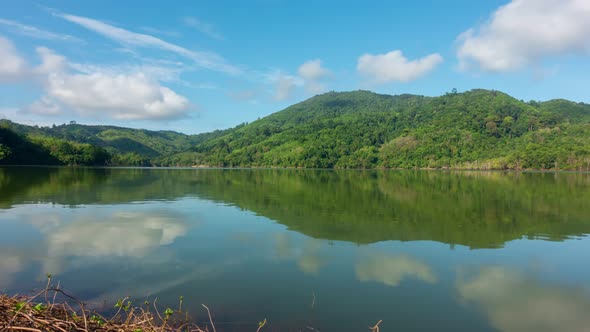 Beautiful reflection of clouds in water surface over lake or pond with Mountain tropical forest