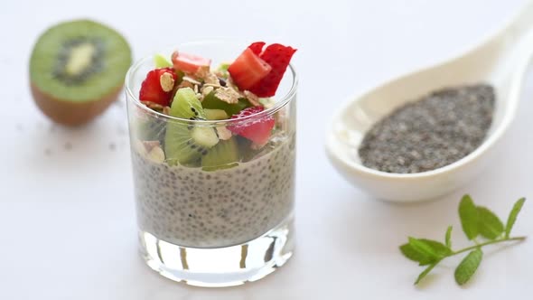 Healthy vegan chia pudding in a glass with vegan milk and fresh berry