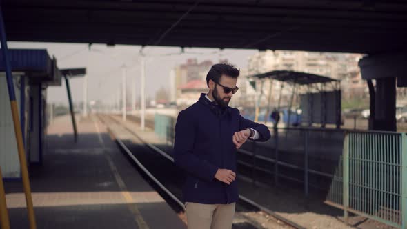 Man Waiting Tram On Tram Station.Businessman Standing On Railway Train Station Platform.City Tourist