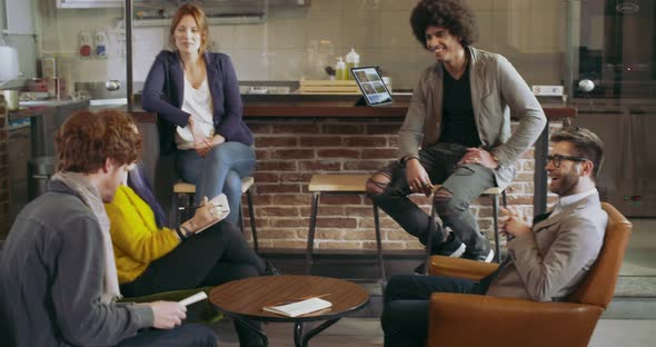 Colleagues and Clients Talking Strategy with Laptop and Tablet