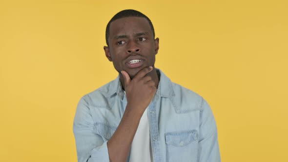 Young African Man Thinking Getting Idea, Yellow Background 