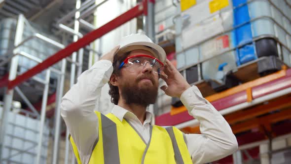 Low Angle View of Positive Warehouse Manager Putting on Helmet