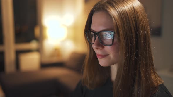 Woman in Glasses Looking on the Monitor and Surfing Internet