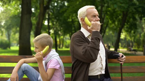 Boy and Grandfather Using Banana as Phones, Playing Funny Game Together, Joke