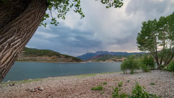 Time lapse viewing lake at sunset as clouds move through the sky