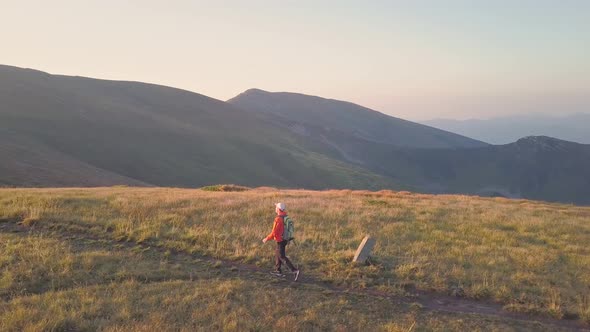 Tourist Hiker with a Backpack Walking on Mountain Path in Carpathian Mountains