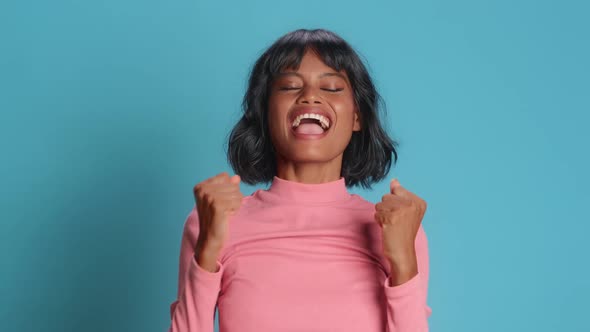 Happy Young Woman Makes Triumph Gesture Says Yes I Did It Makes Victory Dance