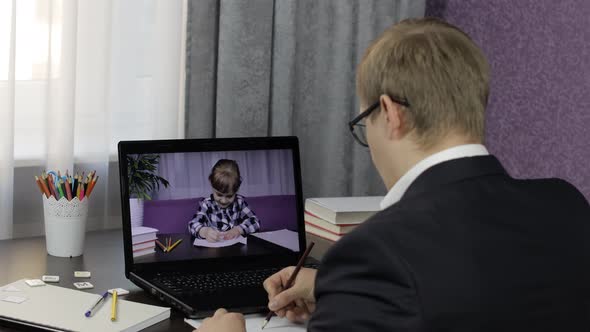 Man Teacher Makes Video Call on Laptop with Children Pupil. Distance Education