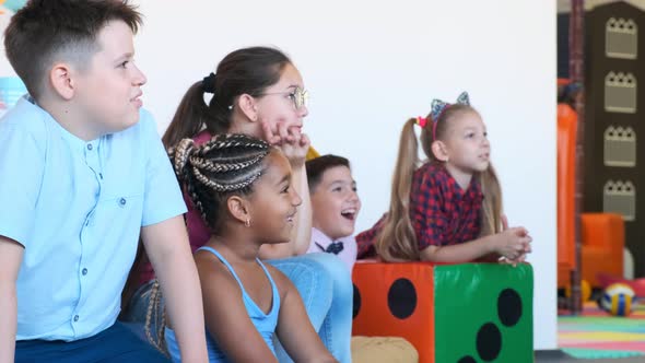 AfricanAmerican Girl with Friends Enjoys Show at Birthday