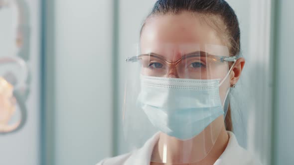 Portrait of a Doctor in a Protective Mask and Goggles