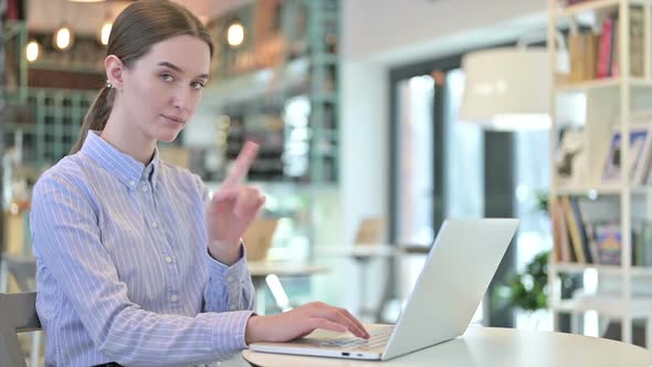 No Sign By Businesswoman Using Laptop in Cafe