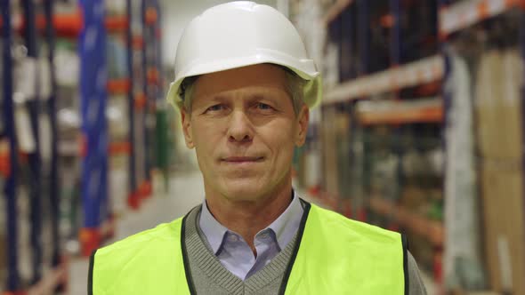 Mature Male Supervisor Senior Contractor Smiling Encouragingly to Camera