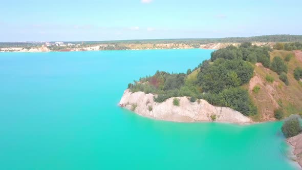 An artificial lake in chalk quarry. view from drone. Turquoise water background