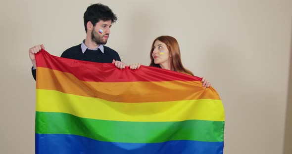 Sad Boy and Girl Couple Waving the Peace Flag to End the War in Ukraine