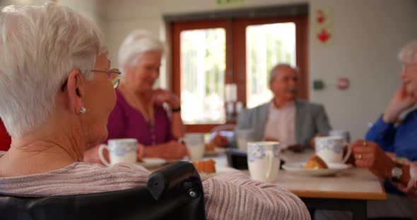 Group of Mixed-race senior friends eating breakfast on dining table 4k