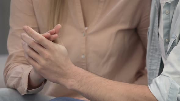 Passionate Young Couple with Connected Hands Expressing Temptation and Desire