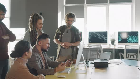 Manager Talking to Team of Businesspeople in Office