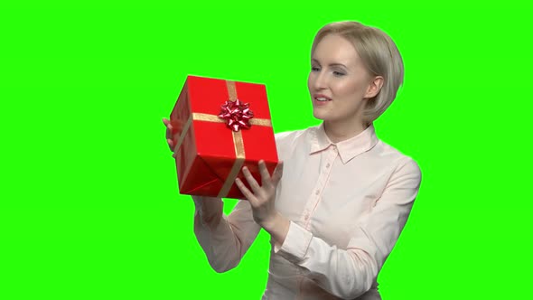 Woman Shaking Gift Box with Excitement