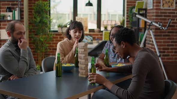 Multiethnic Group of Friends Playing Tower Society Game