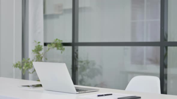 Middle Aged Man Opening Laptop while Sitting in Office